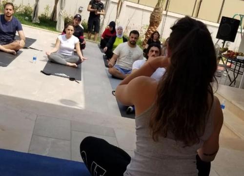 Diala leading an outdoor seated class
